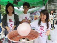 Students making cotton candies for visitors